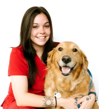 A portrait photo of Lead Kennel Assistant Madison with a Golden Retriever 